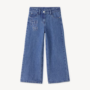 Pantalón recto ancho para niña con parches de lazo. 