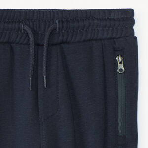 Pantalón de chándal de felpa lisa con bolsillos con cremallera niño 