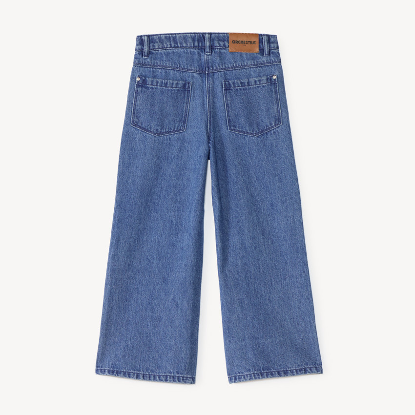 Pantalón recto ancho para niña con parches de lazo. 