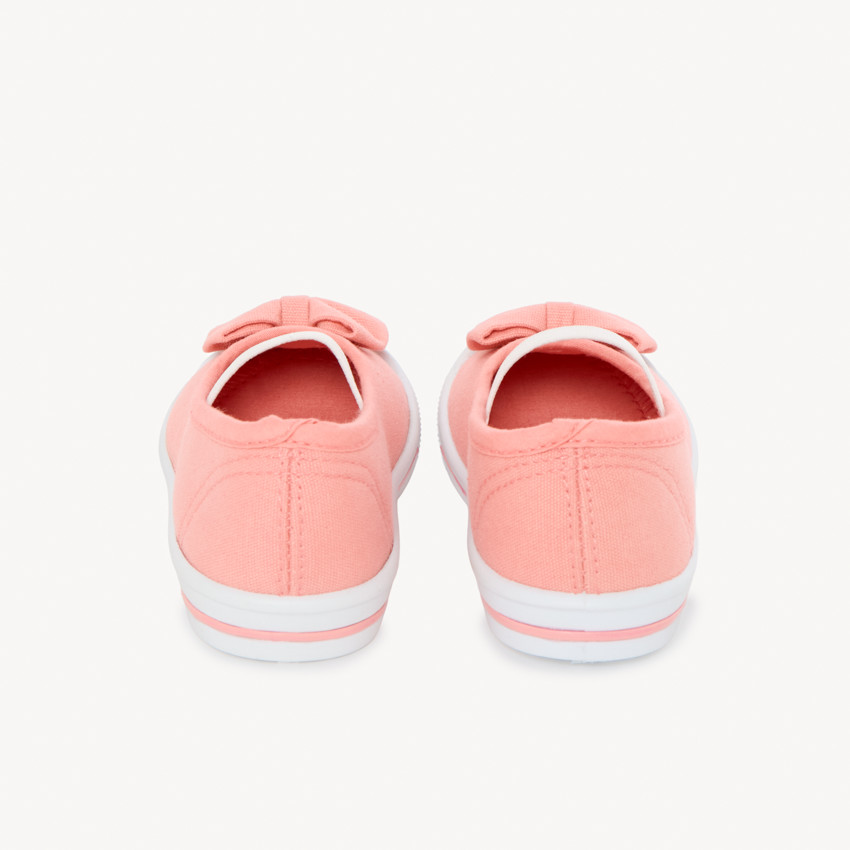 Zapatillas de lona rosa claro para niñas con lazo y banda elástica. 