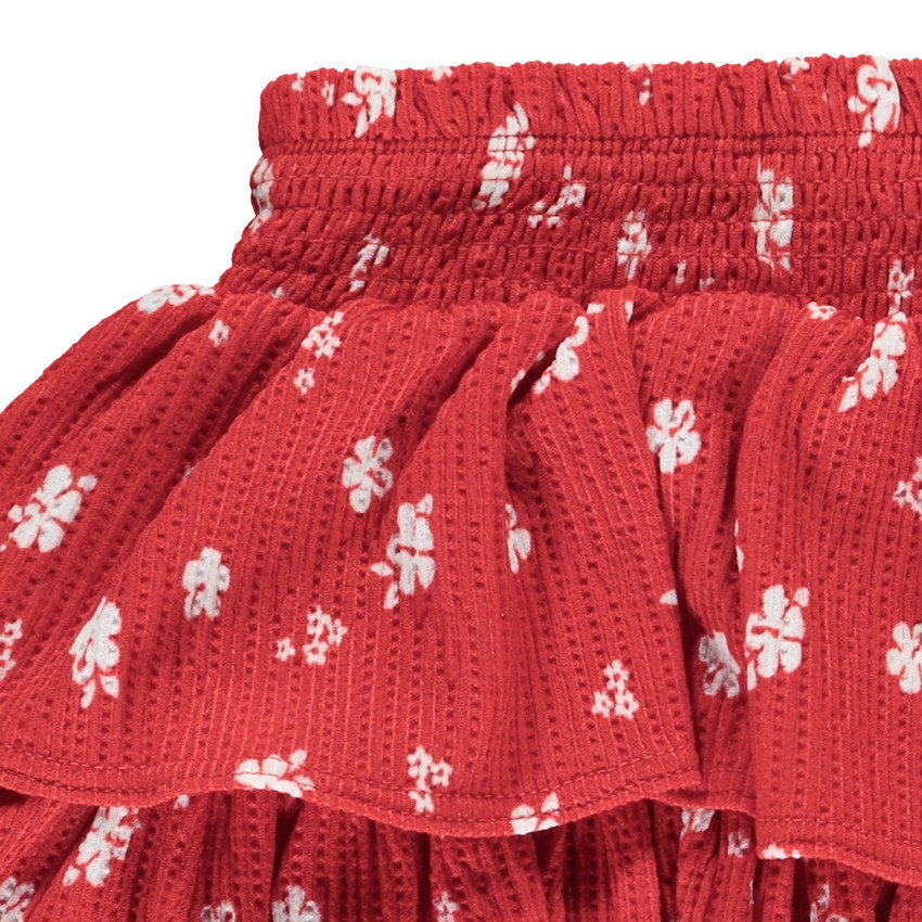 Falda corta de punto calado y estampado con volantes para niña 