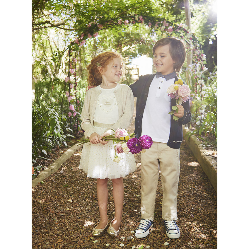 Gilet corto de punto con base festoneada para niña 