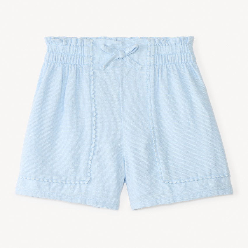Short de tela con galón de pompones para niña 