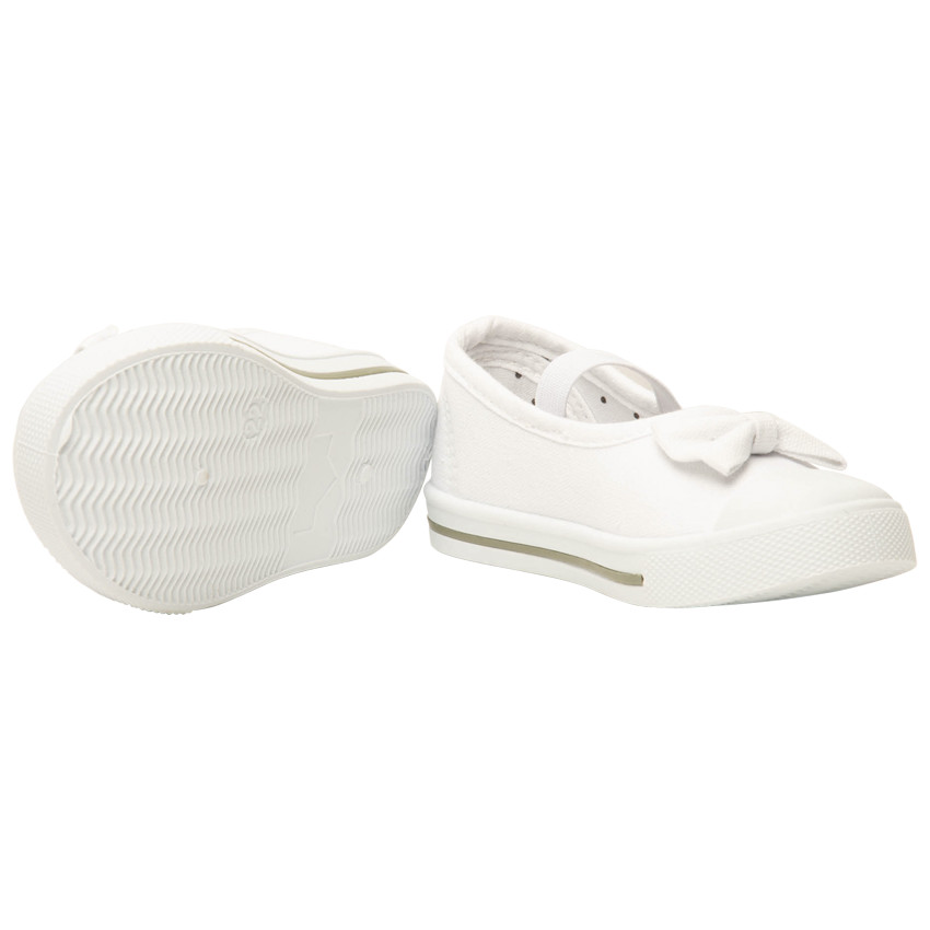 Babies blancas de lona con lazo y tirante elástico para niña 