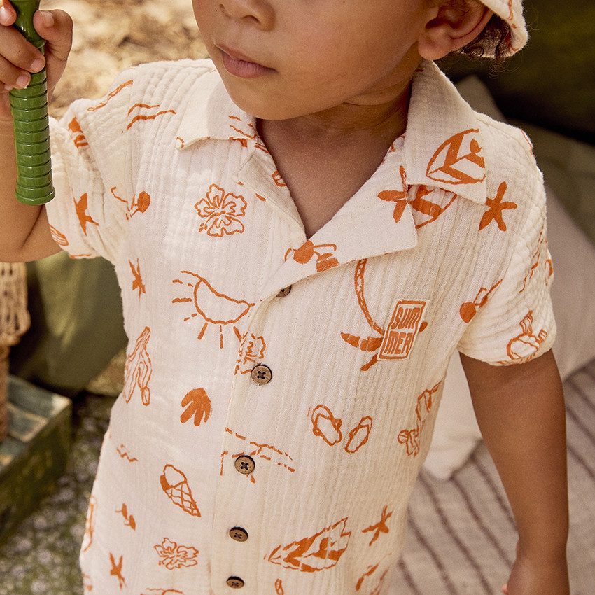 Combinaison corta en tetra estampado vacaciones para bebé niño 