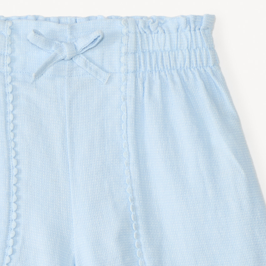 Short de tela con galón de pompones para niña 