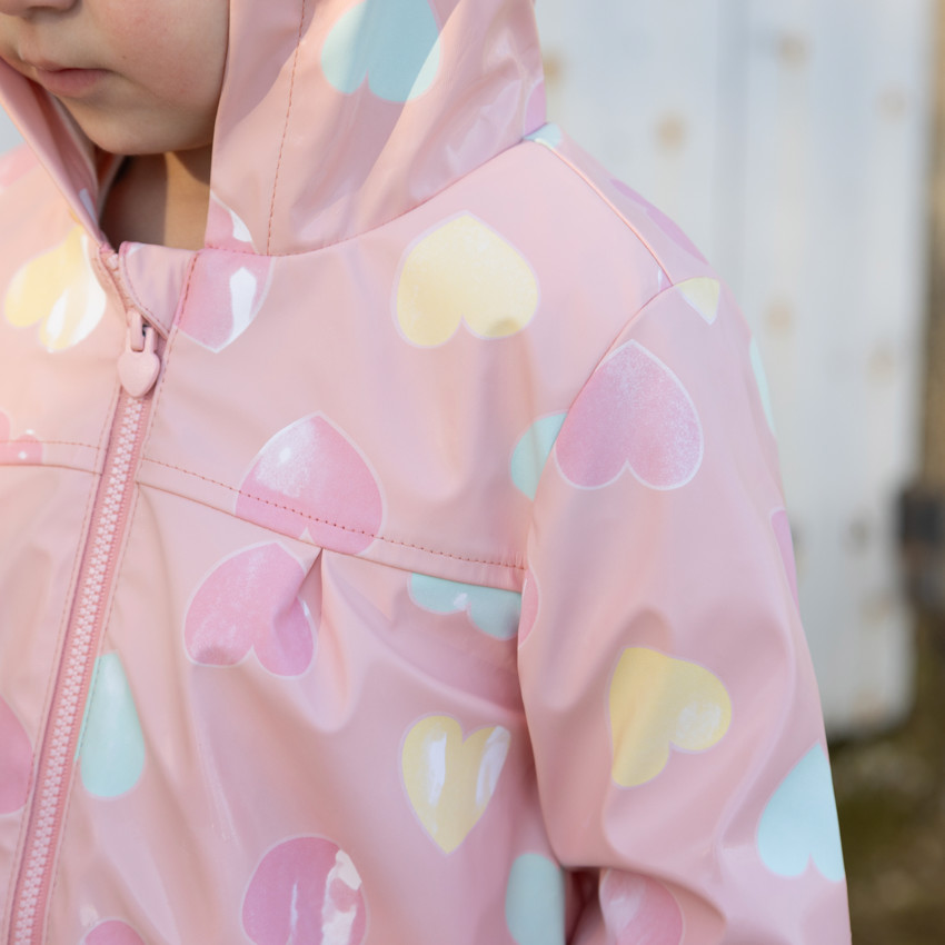Parka de goma con colores cambiantes estampada de corazones para niña. 